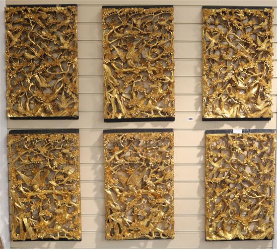 A set of six Chinese carved giltwood panels of birds amid prunus